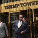 Then-Republican presidential candidate Herman Cain exits Trump Towers to speak with the media before a scheduled appearance with real estate mogul Donald Trump on October 3, 2011 in New York City.